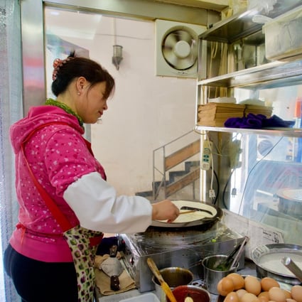 Zhang Lihua prepares Shandong jianbing at a small restaurant in the eastern suburbs of Beijing. Small businesses make up almost 90 per cent of global firms and the majority of employment, but their access to global credit and markets will remain limited without greater interoperability in trade finance systems. Photo: Tom Wang