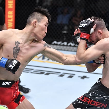 Aori Qileng of China punches Cody Durden in their flyweight fight at UFC Vegas 43. Photos: Chris Unger/Zuffa LLC
