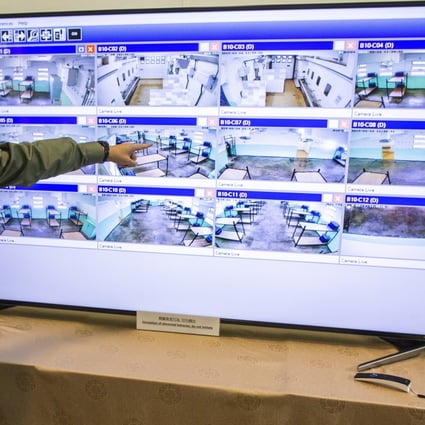 A prison guard shows the artificial intelligence facial recognition video analytics system being tried out at Pik Uk Prison in Sai Kung in 2019. Photo: EPA-EFE