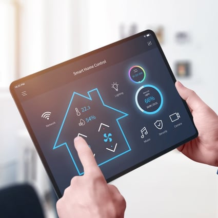 A person uses an all-in-one smart home control system. Photo: Shutterstock