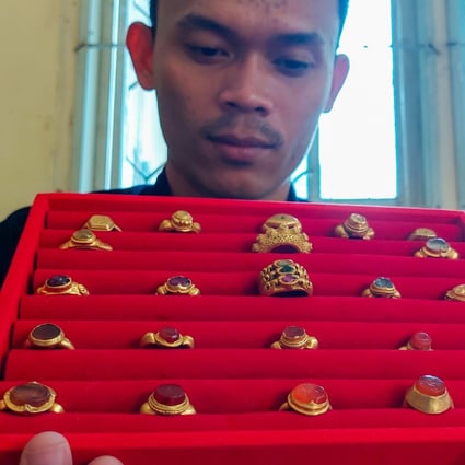 Diver and collector Asmadi shows off some items from his gold ring collection. Photo: Hafidz Trijatnika