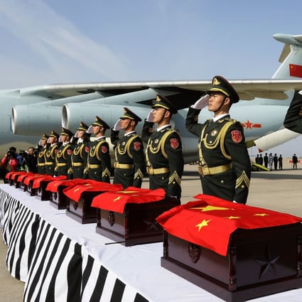 Chinese soldiers salute coffins containing the remains of Chinese military personnel who died during the 1950-53 Korean War, at Incheon International Airport in South Korea. Photo: EPA 