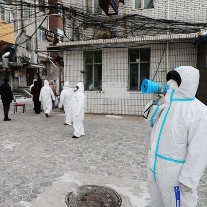 Officials direct residents during mass testing in Manzhouli, which is in the midst of an outbreak. Photo: Reuters