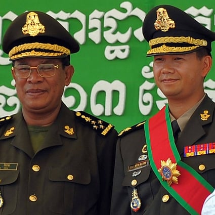 Cambodia’s Prime Minister Hun Sen is seen with his son Hun Manet during a ceremony at a military base in Phnom Penh in 2009. Photo: AFP