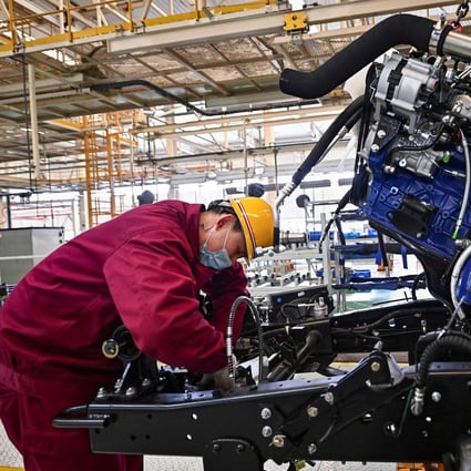 An employee works on a truck assembly line at a factory for Jianghuai Automobile Group Corp in Qingzhou, Shandong province on March 15. Photo: AFP 