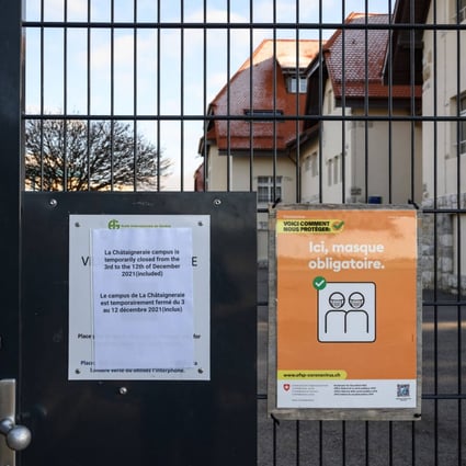 Placards at the entrance of a campus of the International School of Geneva, Switzerland, closed after two cases of the Omicron variant were found on one of the three sites. About 2,000 people, including 1,600 pupils, are in quarantine. 
Photo: AFP
