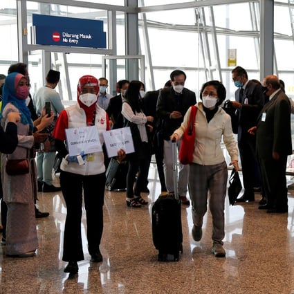 Travellers arrive at the airport in Kuala Lumpur, Malaysia. Photo: Reuters