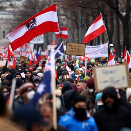Protesters hold flags and placards as they march against coronavirus restrictions and the mandatory vaccination in Vienna, Austria on Saturday. Photo: Reuters 