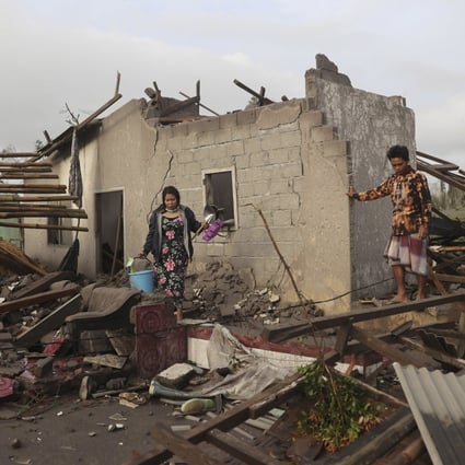 Villagers inspect the damage at their home in an area affected by the eruption of Mount Semeru in East Java. Photo: AP