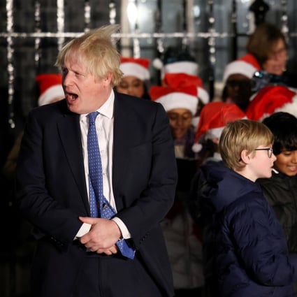 British Prime Minister Boris Johnson stands next to a children’s choir after switching on the Christmas tree lights in Downing Street, London on December 1. Photo: Reuters