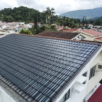 A house with a solar panel-covered rooftop at Hong Lok Yuen in Tai Po in July 2019. Using open space for solar panels and wind farms is one way Hong Kong can help the world achieve its climate change goals. Photo: Winson Wong