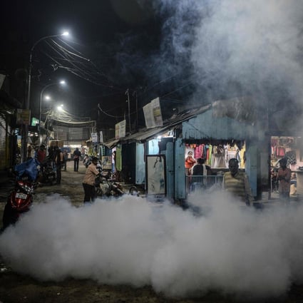 A municipal worker fumigates a market area as preventive measure against mosquito-born diseases in Siliguri, India. Photo: AFP