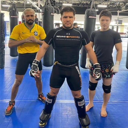 Henry Cejudo (centre) poses with Zhang Weili (right) and Deiveson Figueiredo at the Fight Ready gym in Scottsdale, Arizona. Photo: Instagram/Henry Cejudo