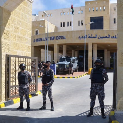 Police officers stand guard at the gate of the Salt government hospital in the city of Salt, Jordan on March 13. Photo: Reuters