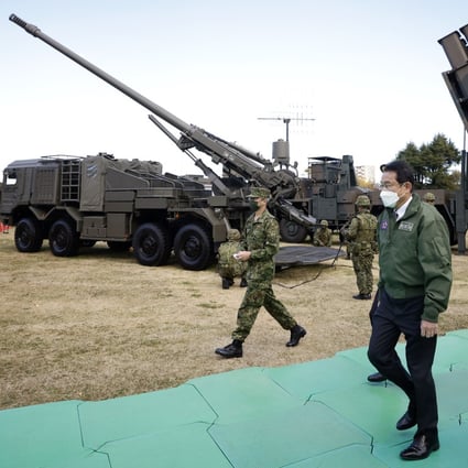 Japanese Prime Minister Fumio Kishida passes a Japan Ground Self-Defence Force Type 19 155 mm wheeled self-propelled howitzer at Camp Asaka in Tokyo. Photo: Bloomberg