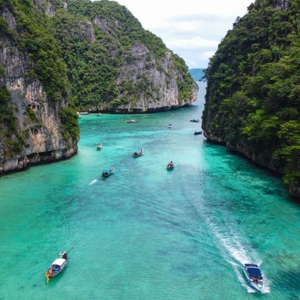 Tourists in longtail boats approach Ko Phi Phi Leh in Thailand. Photo: AFP