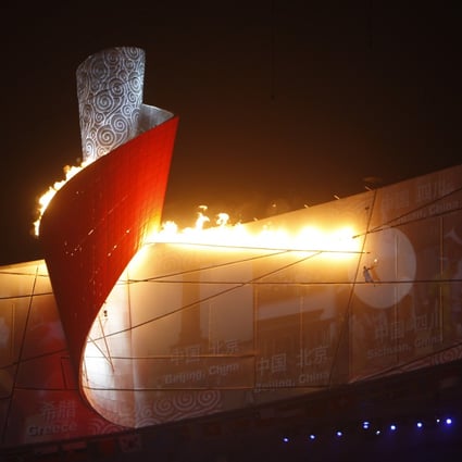 The Olympic flame is lighted during the opening ceremony for the Beijing Summer Games, on August 8, 2008. Photo: Robert Ng