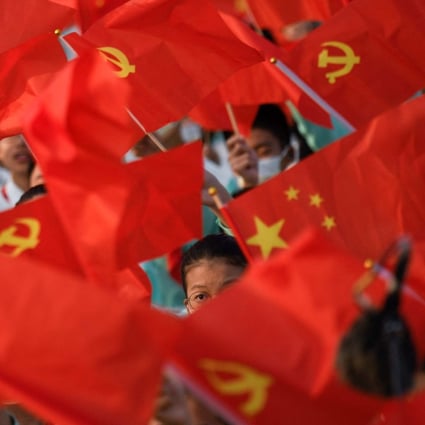 Students wave flags of China and the Communist Party before celebrations in Beijing on July 1 to mark the 100th anniversary of the party’s founding. China has unveiled a white paper titled China: Democracy that Works. Photo: AFP