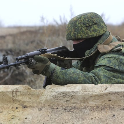 A serviceman holds his Kalashnikov rifle on Thursday as he guards at the line of separation near Sentianivka in Ukraine’s Luhansk region, controlled by Russia-backed separatists. Photo: AP