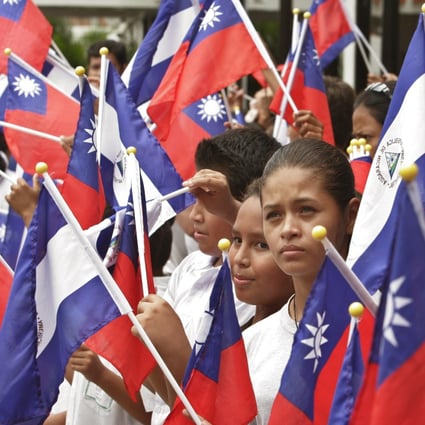 In 2007, Taiwan and Nicaragua relations were solid as students in Managua hold flags representing both nations at a farewell ceremony for then Taiwanese president Chen Shui-bian. Photo: AP Photo