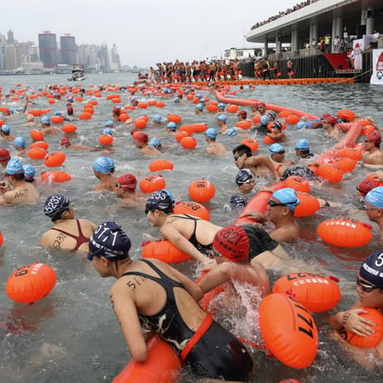 Swimmers from all categories swim across the Victoria Harbour from Tsim Sha Tsui Public Pier to Wan Chai Golden Bauhinia Square Public Pier during the New World Harbour Race 2018. Photo: Robert Ng