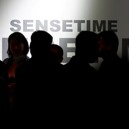 Visitors walk past the stall of artificial intelligence and facial recognition technology company SenseTime at the Security China 2018 exhibition in Beijing on October 23, 2018. Photo: Reuters