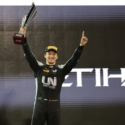 Zhou Guanyu celebrates on the podium after winning the sprint race 2 of the FIA Formula 2 Championship in Abu Dhabi. Photo: Xinhua
