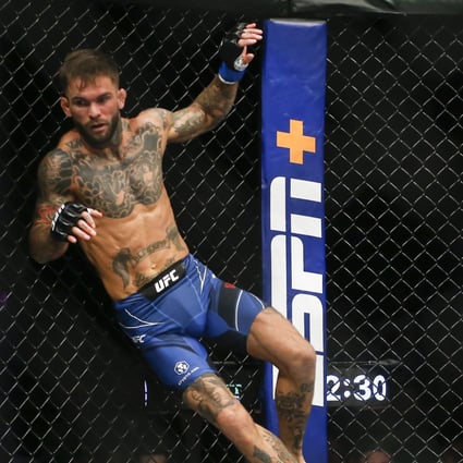 Cody Garbrandt gets knocked back by Kai Kara-France during their flyweight bout at UFC 269. Photo: AP/Chase Stevens