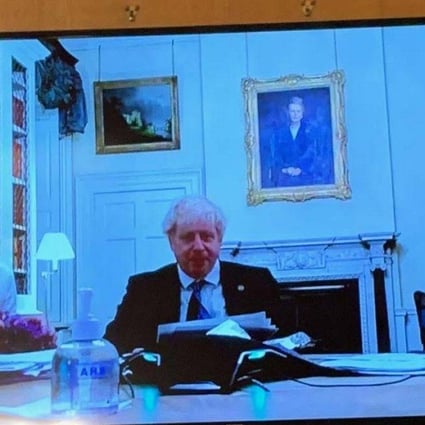 Britain’s prime minister Boris Johnson poses questions during a Christmas 2020 quiz with aides in tinsel and Santa hat. Photo: Sunday Mirror 