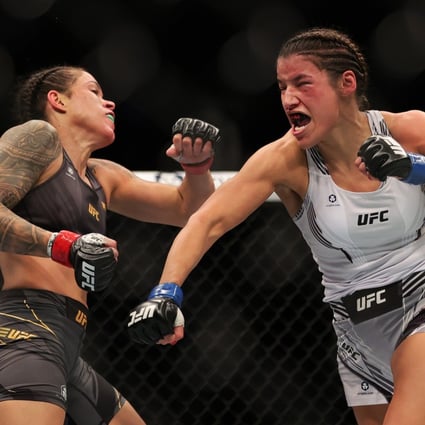 Julianna Pena punches Amanda Nunes in their women’s bantamweight title fight at UFC 269. Photo: Carmen Mandato/Getty Images/AFP