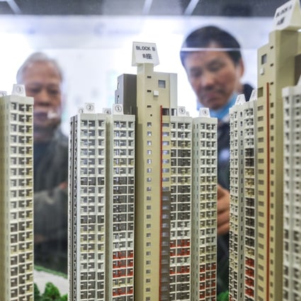 Potential homebuyers look at a scale model of Home Ownership Scheme flats at the Customer Service Centre of the Housing Authority in Lok Fu on December 9, 2019. Photo: SCMP / Dickson Lee