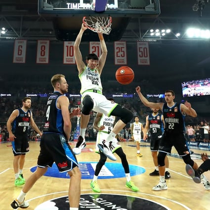 Zhou Qi slam dunks during a round two NBL match between Melbourne United and South East Melbourne Phoenix. Photo Getty Images