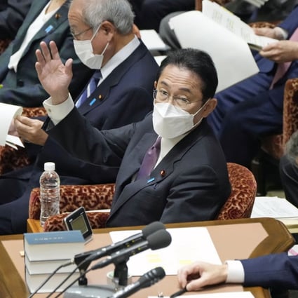 Japanese Prime Minister Fumio Kishida raises his hand to speak during a House of Representatives Budget Committee session in Tokyo on December 15. Photo: Kyodo