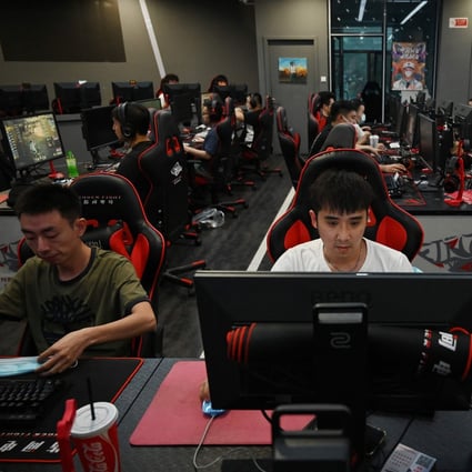 People play computer games at an internet cafe in Beijing on September 10, 2021. Photo: AFP 
