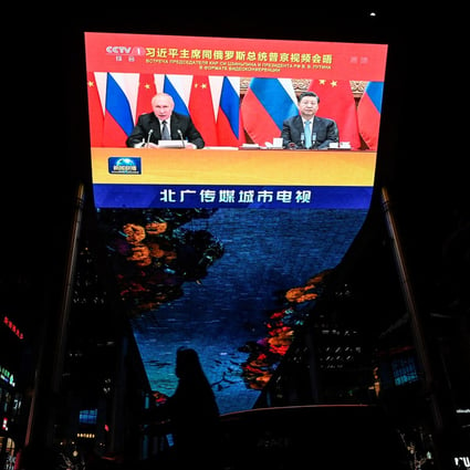 An outdoor screen in Beijing shows a news programme of a virtual meeting between Chinese President Xi Jinping and Russian President Vladimir Putin. Photo: AFP