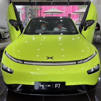 Two consumers check out an Xpeng P7 intelligent electric car at the company’s showroom in Beijing. Photo: Simon Song