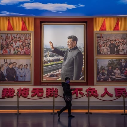 A visitor walks in front of pictures of Chinese President Xi Jinping at the Museum of the Communist Party of China in Beijing on November 23. Photo: EPA-EFE