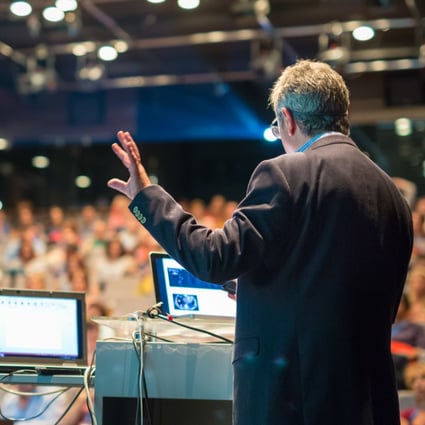 A presenter addresses a busy lecture hall, though in the era of Covid-19, even courses at master’s level and above have been forced to embrace online learning. Photo: Shutterstock