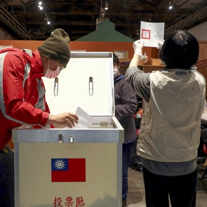 Electoral workers count votes for the four-question referendum in Taipei. Photo: Reuters 