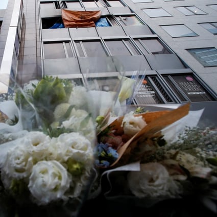 Flowers by the building where a deadly fire broke out in an Osaka clinic. Photo: Reuters