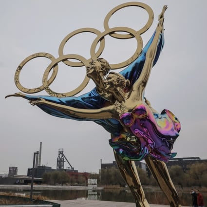 The Olympic rings rest on a statue of a figure skating couple near the headquarters of the 2022 Beijing Winter Olympics organising committee. Photo: EPA-EFE