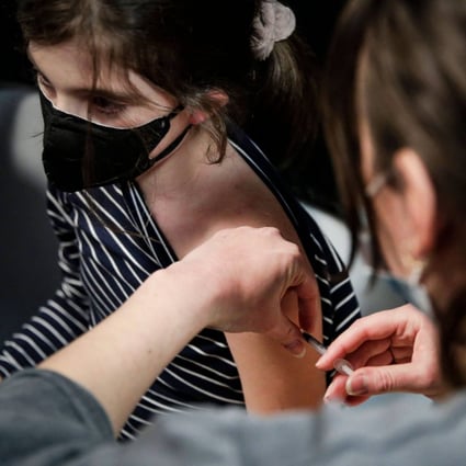 A girl receives a dose of the Pfizer/BioNTech vaccine in Paris, France. Vaccination against Covid-19 will be proposed to children aged 5 to 11 years from December 22 “if all goes well”, said French Minister of Health Olivier Veran. Photo: AFP