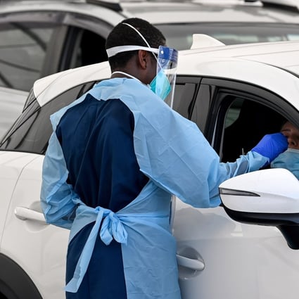 Health care workers administer Covid-19 tests at a drive-through testing clinic at Bondi Beach in Sydney. Photo: EPA-EFE