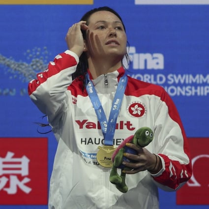 Siobhan Haughey stands on the podium after winning gold in the women’s 100m freestyle at the short-course World Championships. Photo: AP