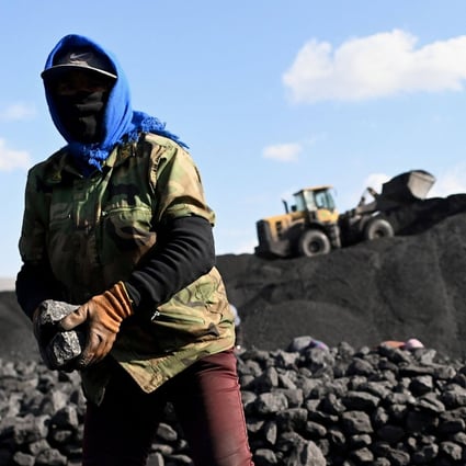 A worker sorts coal near a mine in Datong, in China’s northern Shanxi province, on November 3. Many rural areas rely on coal as their only source of power. Photo: AFP
