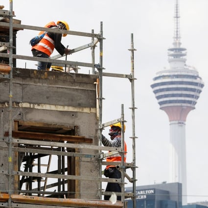 Labourers work at a construction site in Kuala Lumpur, Malaysia. Photo: Reuters