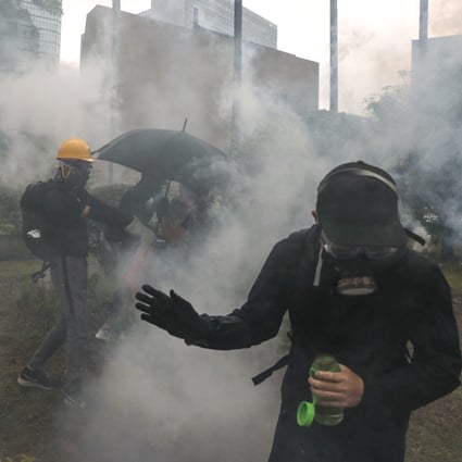 Anti-government protesters react to tear gas in Wan Chai on October 5, 2019. Photo: Sam Tsang