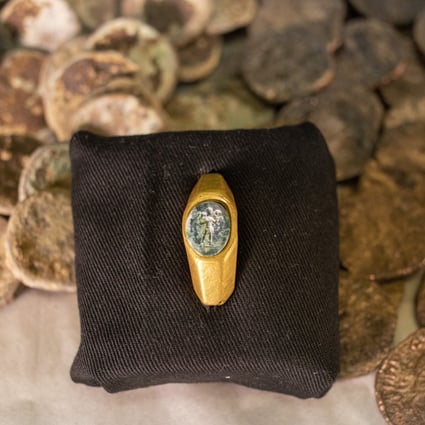 A Roman gold ring, its green gemstone carved with the figure of a shepherd carrying a sheep on his shoulders. Photo: AP