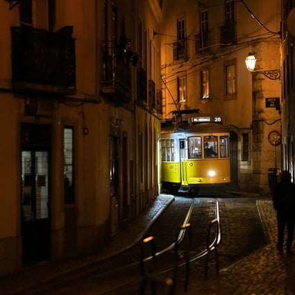 A tram makes its way through a narrow street in Lisbon’s old Alfama neighbourhood. Photo: AP