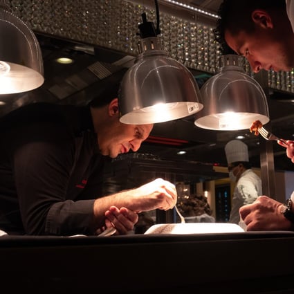 Chef Guillaume Galliot (left) of Caprice works meticulously on his latest creation. The adaptability of Hong Kong chefs during Covid-19 will be celebrated in new Discovery Channel show Kung Food! Hong Kong’s Grandmasters of Cuisine. Photo: Discovery